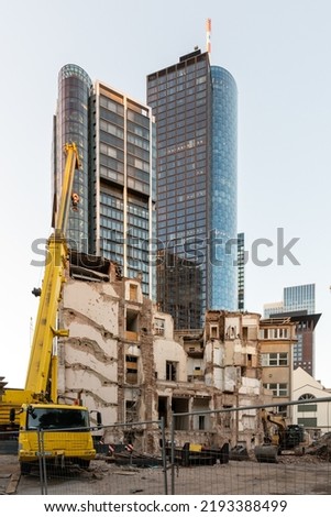 Urban renewal or Gentrification. Old buildings are being demolished to create space for new high-rise buildings. Royalty-Free Stock Photo #2193388499