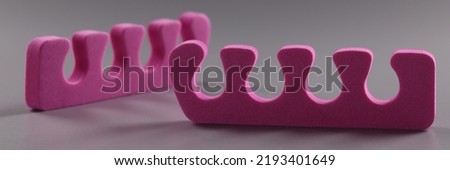 Pink toe separators, pair of equipment for pedicure procedure