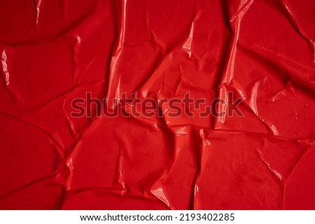 Red background. Wet and wrinkled sheet of paper. Background mockup.
