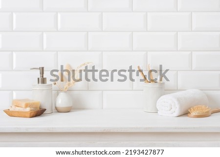 Tile wall and shelf in bathroom with various hygiene accessories Royalty-Free Stock Photo #2193427877