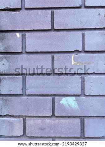 Vertical pastel purple colour painted brick wall close up texture