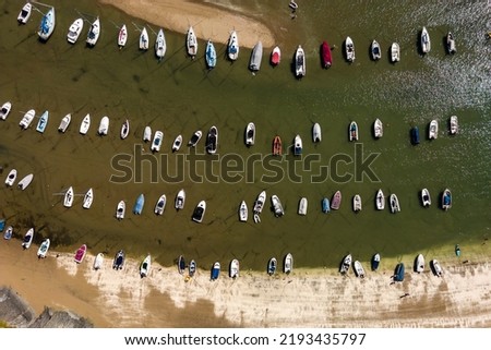 Aerial view of boats in a dry harbour at low tide (New Quay, Ceredigion, Wales) Royalty-Free Stock Photo #2193435797