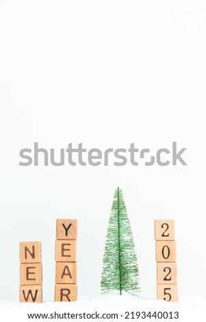 Close up photo of mini christmas tree with word new year