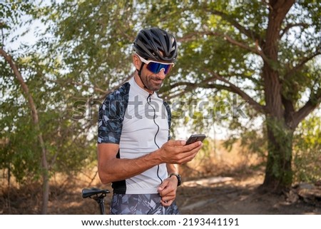 The cyclist checks the route on his smartphone. Sport Fitness Motivation And Inspiration. Extreme sport, Triathlon.