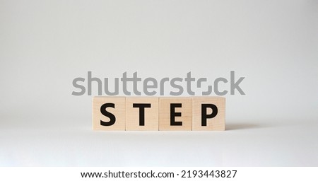 Step symbol. Concept word Step on wooden cubes. Beautiful white background. Business and Step concept. Copy space