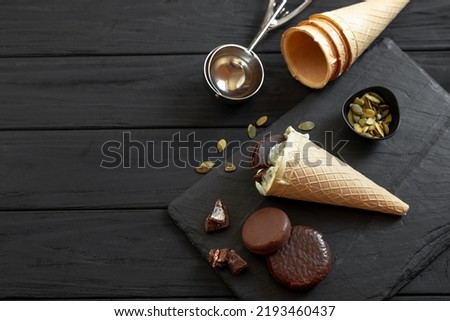 The process of making homemade ice cream on a black background. Ingredients for making ice cream on a wooden background