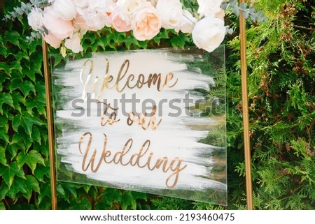 Blank signpost pointer on a wooden easel in a frame with a wreath. Welcome inscription Forest Wedding.