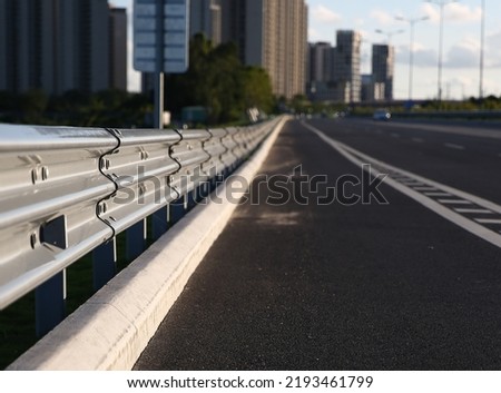 Traffic barrier on bridge highway road. Median crash barriers for protect vehicles from accident.  Industrial city background. Royalty-Free Stock Photo #2193461799