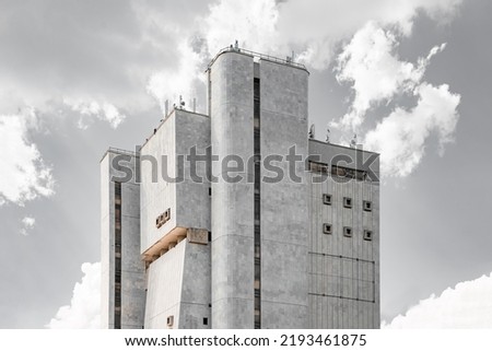 Soviet Brutalist Architecture. High gray walls with small windows. Old Soviet building Royalty-Free Stock Photo #2193461875
