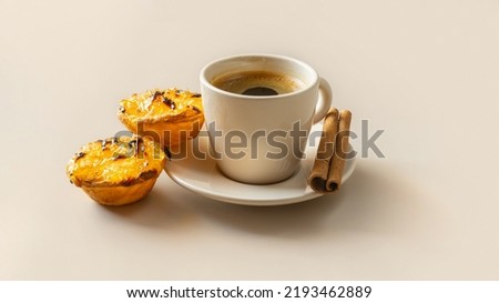 Typical Portuguese dessert pastel de chila - pastry tarts of squash with a cup of coffee on beige background