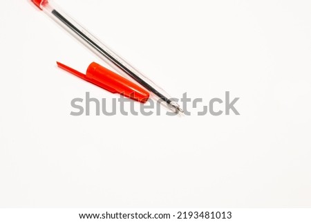 Ballpoint pen with red ink on a white isolated background