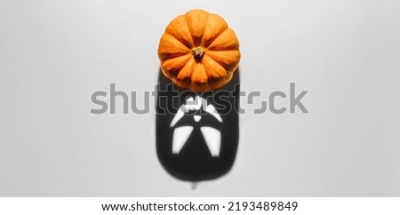 Halloween background concept. Jack O pumpkin angry face shadow. Spooky smiling shadow of an orange pumpkin lantern top view close up, Halloween party design