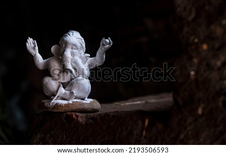Unpainted clay model of lord Ganesh holding Dinka, the mouse