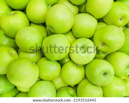 Background of juicy, ripe fruits. Green apples, close-up. Natural background. View from above. Copy space
