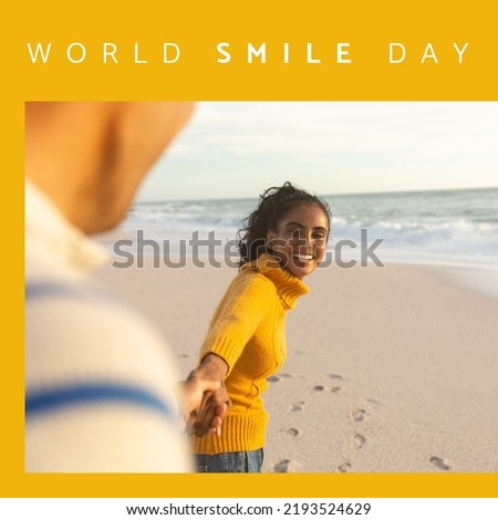Composition of world smile day text over biracial woman smiling on orange background. World smile day and celebration concept digitally generated image.