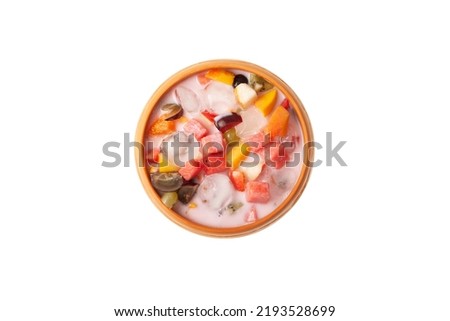 Es Campur or Es Buah isolated on white background, top view. Fruit soup with yogurt and shaved ice in clay bowl. Design elements for street cafe or restaurant. Popular indonesian fruits dessert. Royalty-Free Stock Photo #2193528699