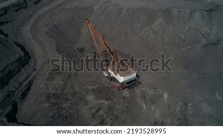 Top view, camera fly over working walking excavator in quarry of Kusbass coal deposit Royalty-Free Stock Photo #2193528995