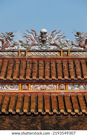 Hue Royal Antiquities Museum.  Roof detail with dragon.  Ceramic tiles.  Hue. Vietnam. 