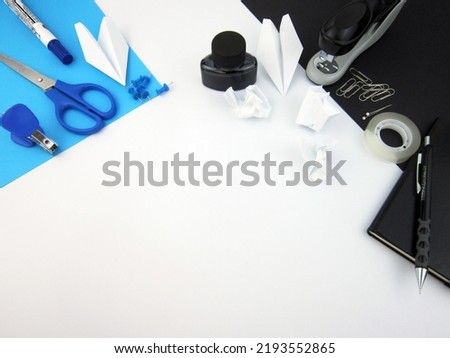                 Creative trendy minimalist school or office workspace with blue and black materials on a white background.                           