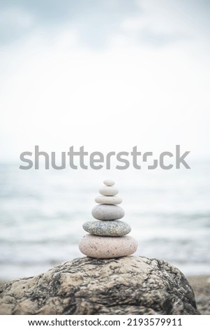 Pebble tower balance harmony stones arrangement on sea beach coastline. Relaxing peaceful formation pyramid cobblestone philosophy equilibrium spiritual tranquility. Spa therapy summer travel vacation Royalty-Free Stock Photo #2193579911