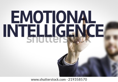 Business man pointing to transparent board with text: Emotional Intelligence