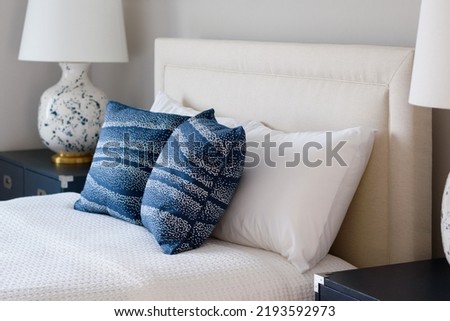 Hotel or Bed and Breakfast Guest Room Bed with White Bedspread, Pillows and Lamps Royalty-Free Stock Photo #2193592973