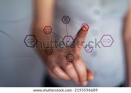 Woman about to edit a contact in her contact book by pressing her finger on the icons on her virtual screen.