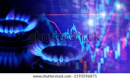 Natural gas cost growth concept with gas burners and stock charts Royalty-Free Stock Photo #2193596875