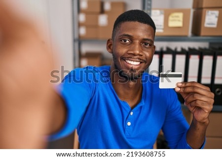 Young african american man ecommerce business worker make selfie holding credit card at office