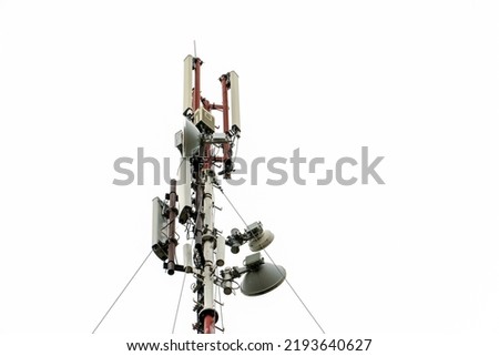 New GSM antennas on a high tower against a blue sky for transmitting a 5g signal are dangerous to health. Radiation pollution of the environment through cell towers. The threat of extinction Royalty-Free Stock Photo #2193640627