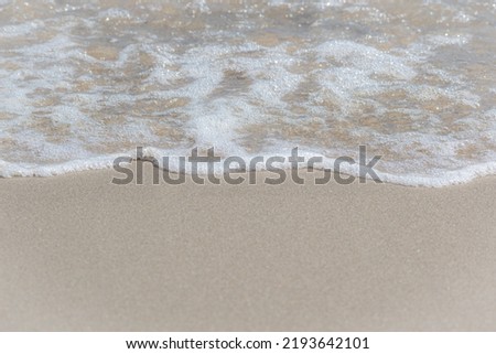 Sunny Beach Shoreline where the Ocean Meets the Light Sand Royalty-Free Stock Photo #2193642101
