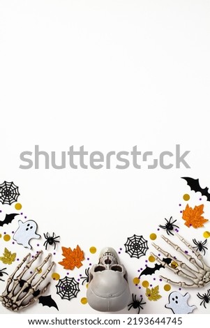Happy Halloween holiday vertical banner design. Frame made of Halloween decorations on white background. Flat lay, top view, copy space.