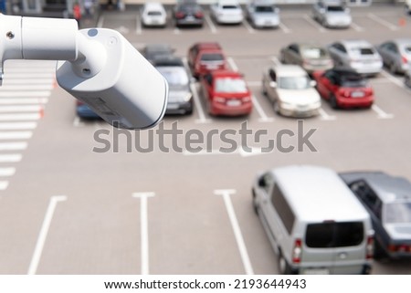 Technician installed IP CCTV camera hi-technology for look security area of work in car parking lot show signage with security cars park in area. Royalty-Free Stock Photo #2193644943
