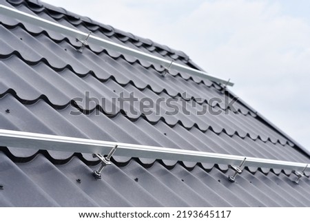 Brackets solar panel mounting system. Process of mounting solar power system on the roof. Turnkey solar power system, service works. Green energy. Rooftop solar power system Royalty-Free Stock Photo #2193645117