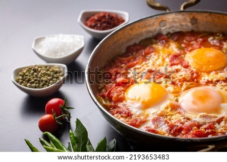 Famous Turkish menemen dinner on table, made by eggs, pepper and tomatoes. Royalty-Free Stock Photo #2193653483