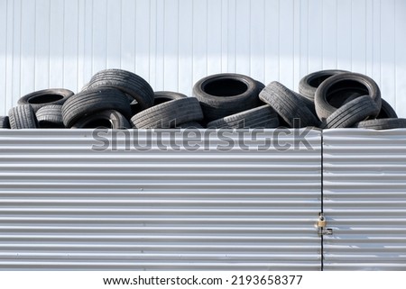 Waste rubber tires at landfill for recycling. Regenerated reuse of the waste car tyres. Pile of old wheels on tyre dump for recycling. Disposal of waste tires. Copy space. Royalty-Free Stock Photo #2193658377