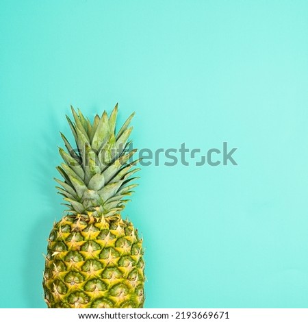 Fresh ripe pineapple on pastel blue background. Flat lay summer concept. Copy space