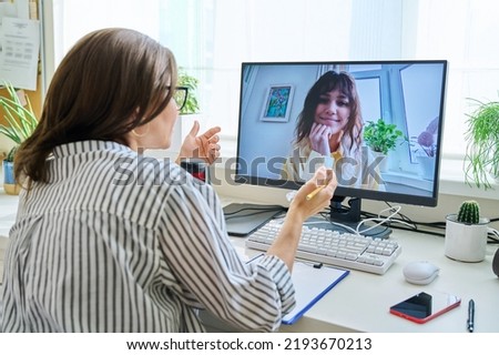 Mature woman talking online with teenage girl using video call Royalty-Free Stock Photo #2193670213