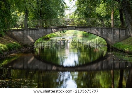 Old Bridge is Reflected in the Green Water