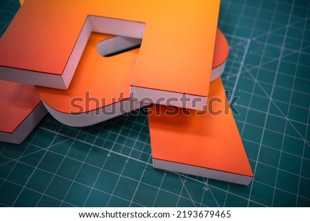 Three-dimensional letters made of plastic.Production of logos and letters of outdoor advertising.Production of signage. Royalty-Free Stock Photo #2193679465