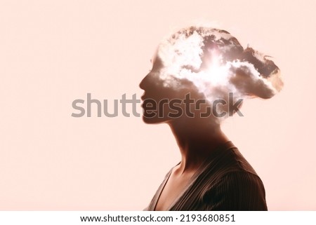 Atmosphere pressure and woman mental health contemplation concept. Multiple exposure clouds and sun on female head silhouette. Royalty-Free Stock Photo #2193680851