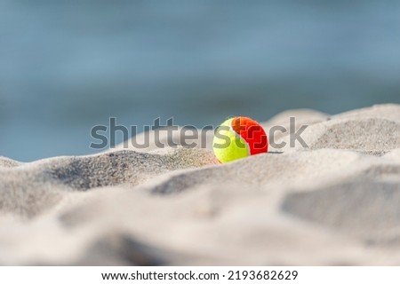 Beach tennis ball on the sandy beach. Summer sport concept. Horizontal sport theme poster, greeting cards, headers, website and app
