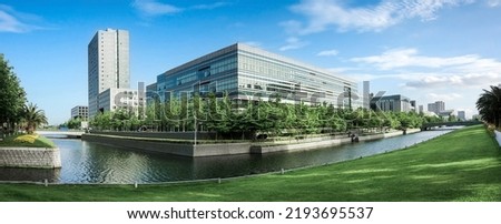 Beautiful landscape abstract city blur background and The light of sun reflection building on water.Panoramic and perspective wide angle skyscraper commercial modern city of future. pastel concept.