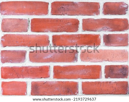 Wall is made of red decorative brick facade decoration. Plaster blocks based on casts of old bricks. Restoration of old buildings and facades. Hobby, craft
