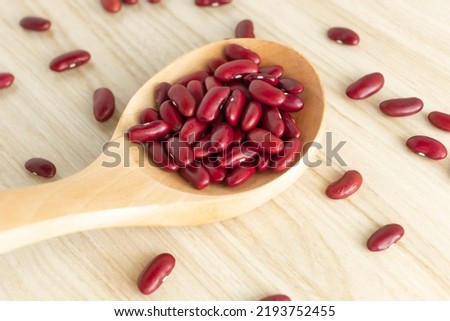 red kidney beans and spoon on wooden background, top view, flat lay, top-down, selective focus.copy space.