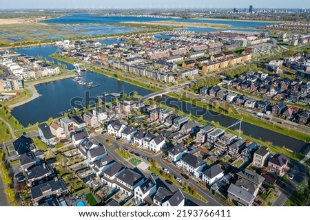 Modern green neighbourhood in Almere, The Netherlands, surrounded by water and nature, city built on reclaimed land (Flevoland polder). Aerial view. Royalty-Free Stock Photo #2193766411