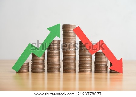 Stack coins and arrow red green graph chart volatility up and down on wooden table background. Business, financial and investment concept. Risk, fluctuation in stock market and cryptocurrency. Royalty-Free Stock Photo #2193778077