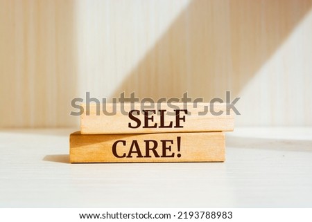 Wooden blocks with words 'Self Care'.