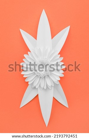 Paper flower with leaves on red background