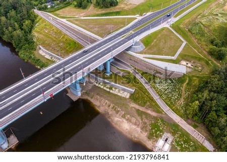 aerial view on huge bridge with a wide multi-lane road across a wide river Royalty-Free Stock Photo #2193796841